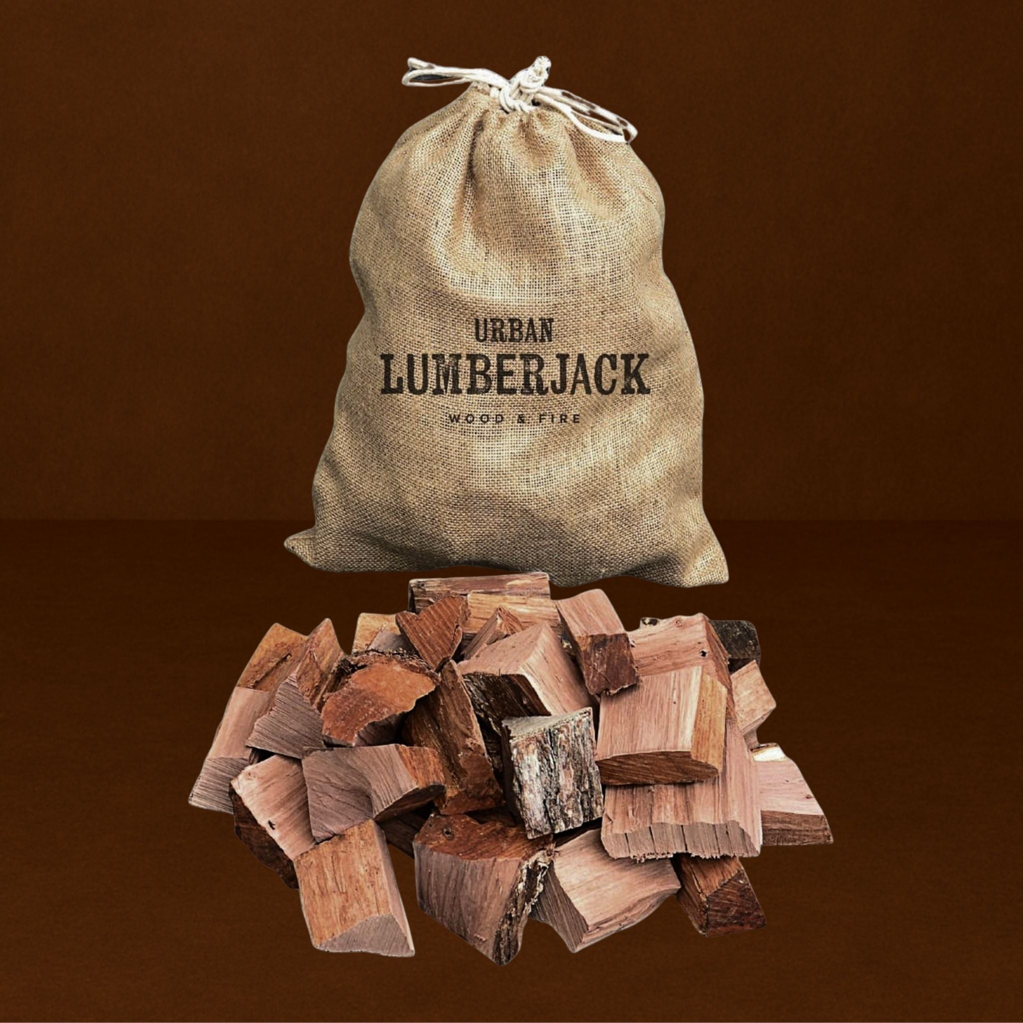 Burlap bag labeled 'Urban Lumberjack' with a pile of firewood on a brown background